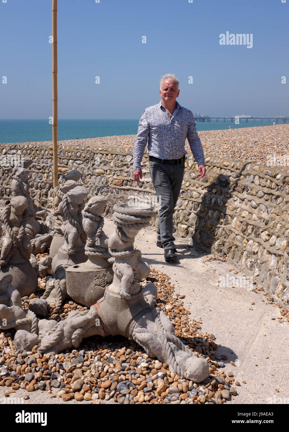 Brighton, UK. 1st June, 2017. Artist Brian Mander among his art installation entitled The Tempest . The Shore at the end of a beach groyne along Brighton seafront iand is part of the Brighton Fringe Festival 2017 . The installation contains a selection of reinforced concrete tetrapods Credit: Simon Dack/Alamy Live News Stock Photo