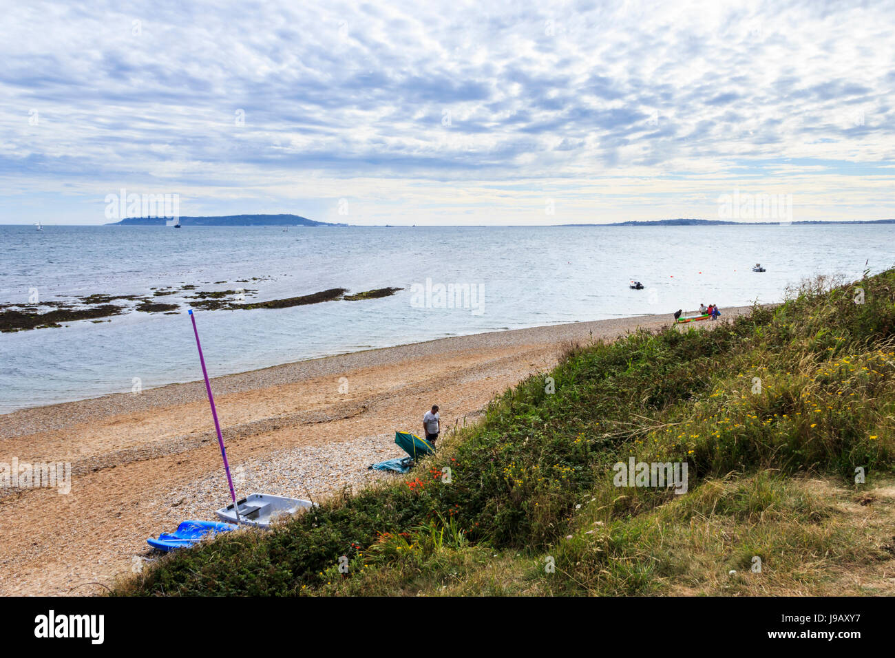 Looking down on the shingle beach from the bluff at Ringstead Bay, Dorset, England, UK, Portland Bill in the distance Stock Photo