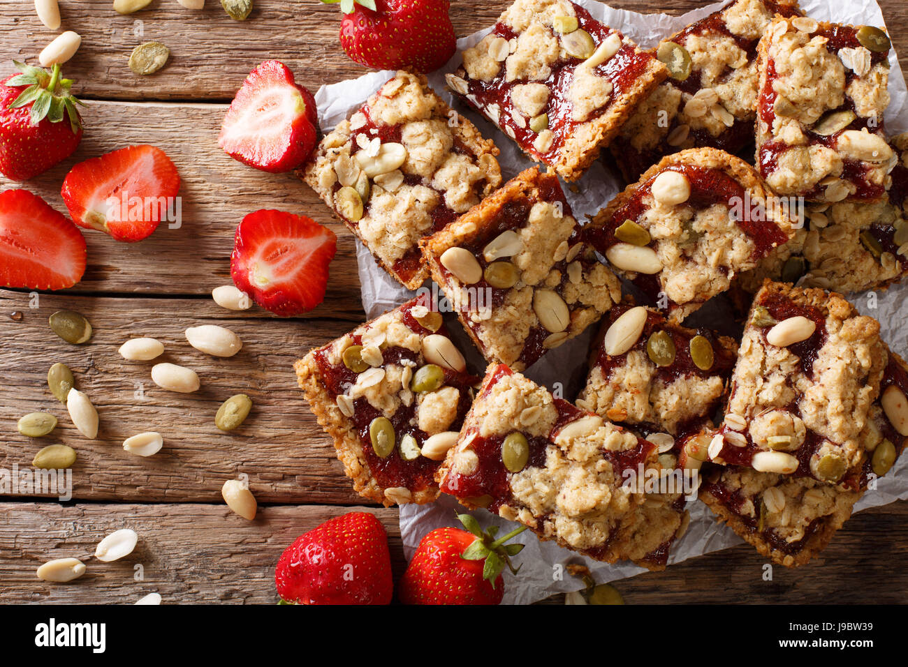 Tasty strawberry bars with oatmeal and nuts close-up on the table. horizontal view from above Stock Photo