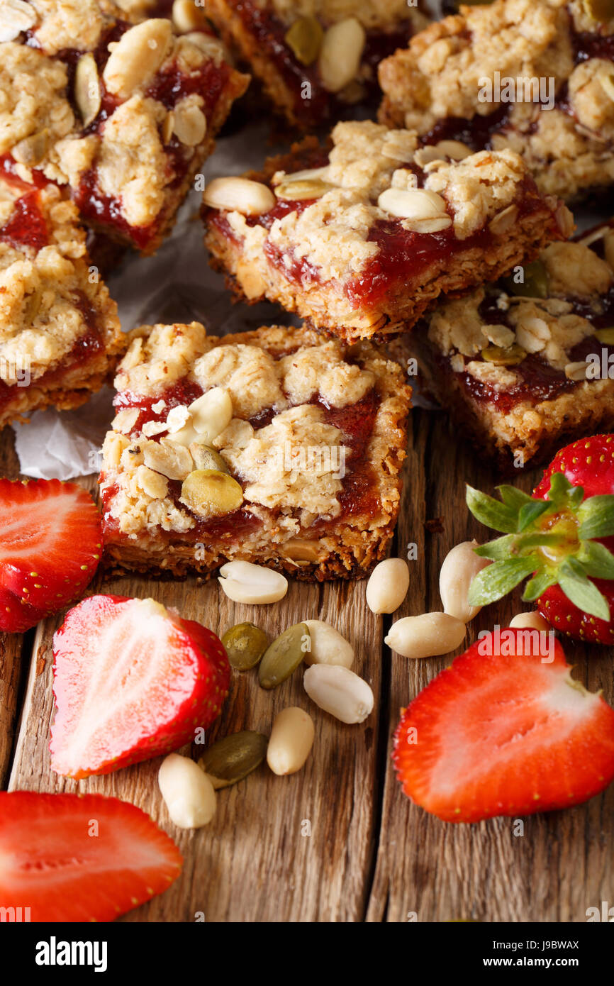 Peanut and Strawberry Jelly Oat Bar Squares close-up on the table. Vertical Stock Photo