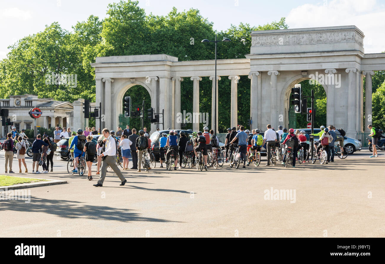 A huge mass of cyclists waiting for the traffic lights to change at Hyde Park Corner, London, UK Stock Photo