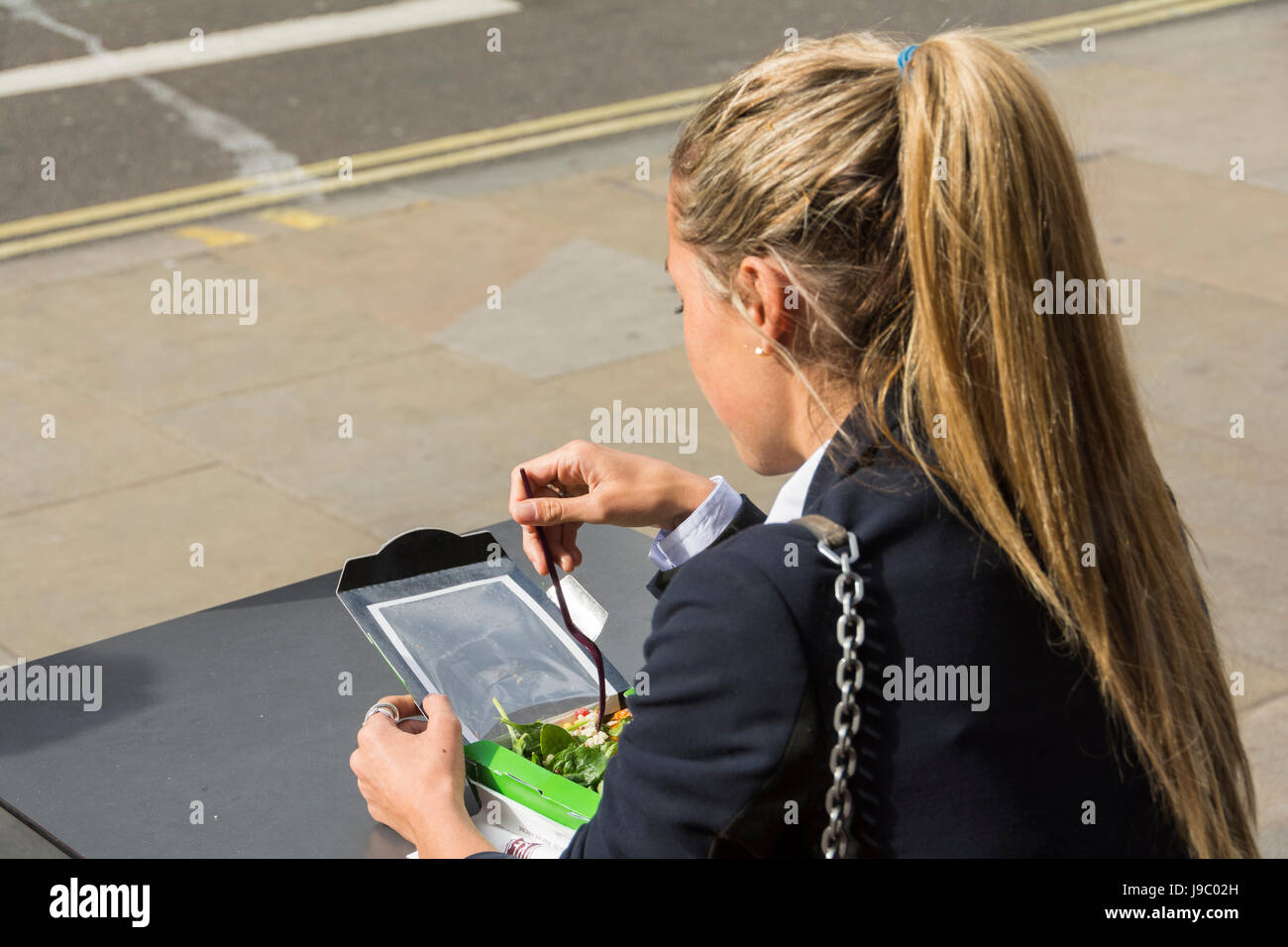A young woman eating a healthy snack by herself Stock Photo
