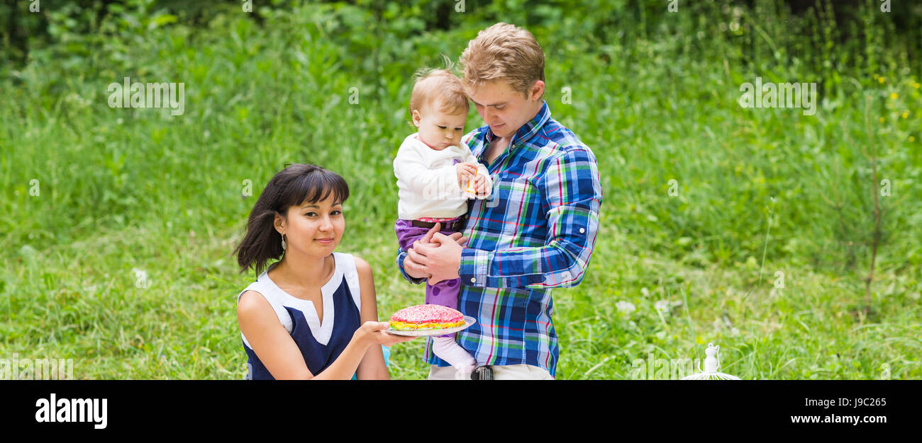 Happy Mixed Race Family Having a Picnic and Playing In The Park Stock ...