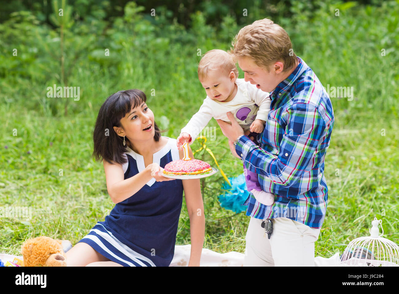 Happy Mixed Race Family Having a Picnic and Playing In The Park Stock ...