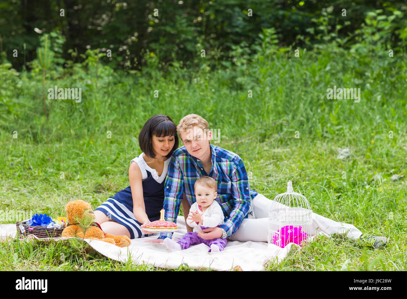 Happy Mixed Race Family Having a Picnic and Playing In The Park Stock ...