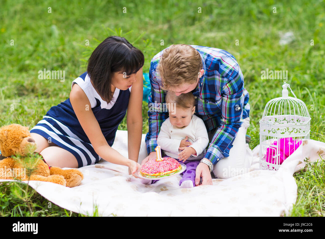 Happy Mixed Race Family Having a Picnic and Playing In The Park Stock ...