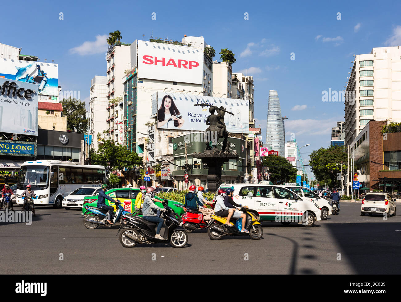 HO CHI MINH CITY, VIETNAM - APRIL 9, 2017: Cars and motorcycles drive through an intersection in the heart of Ho Chi Minh City, the largest city in Vi Stock Photo