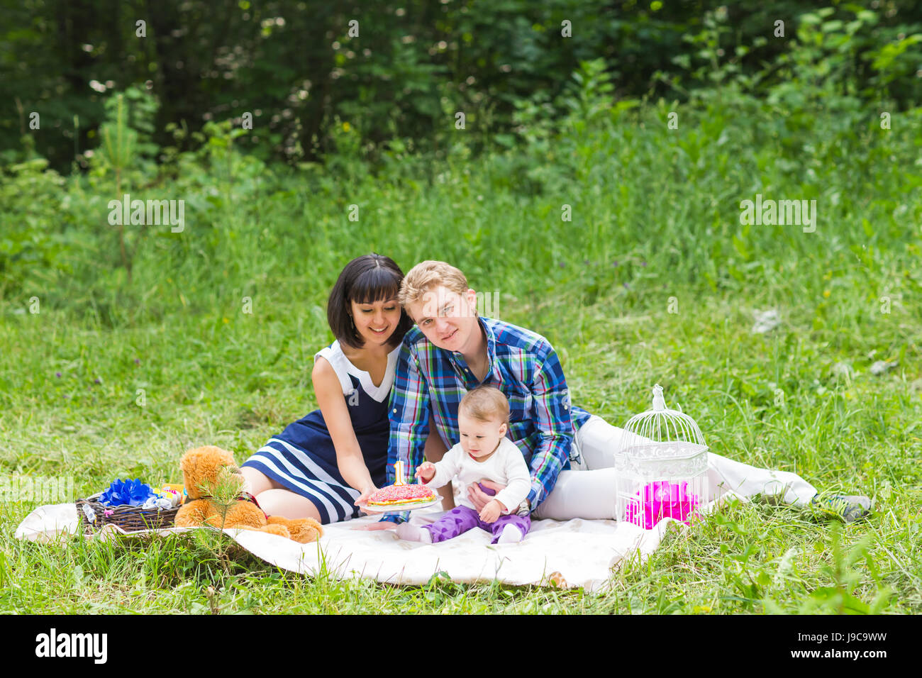 Happy Mixed Race Family Having a Picnic and Playing In The Park Stock ...