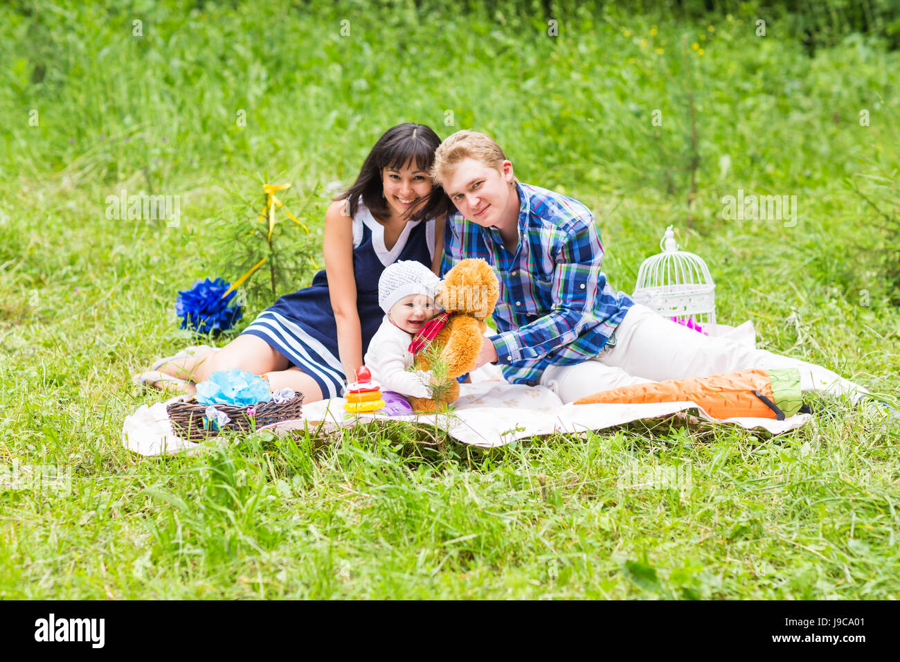 Happy Mixed Race Family Having a Picnic and Playing In The Park Stock ...