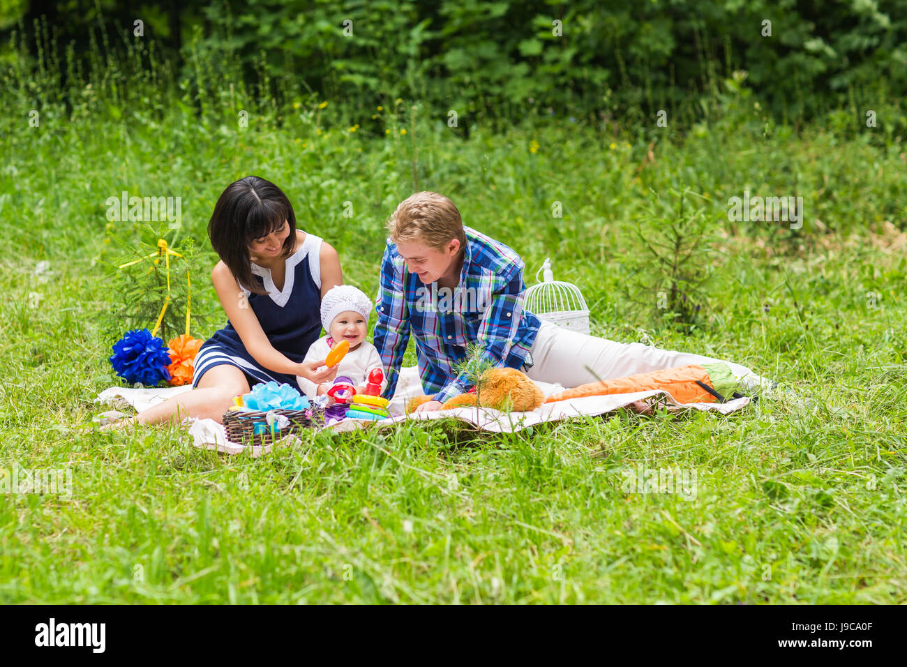 Happy Mixed Race Family Having a Picnic and Playing In The Park Stock ...