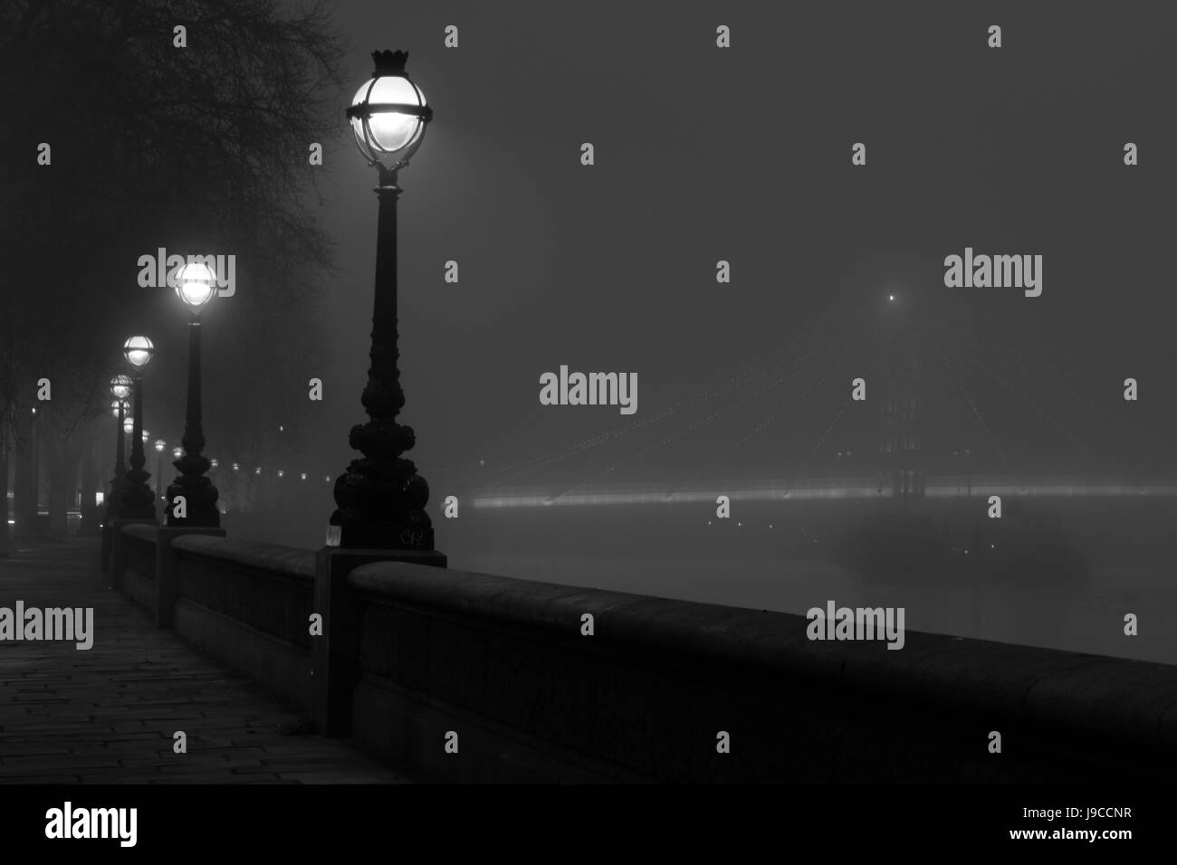 View up Chelsea Embankment to a foggy Albert Bridge, Chelsea, London, England, UK Stock Photo