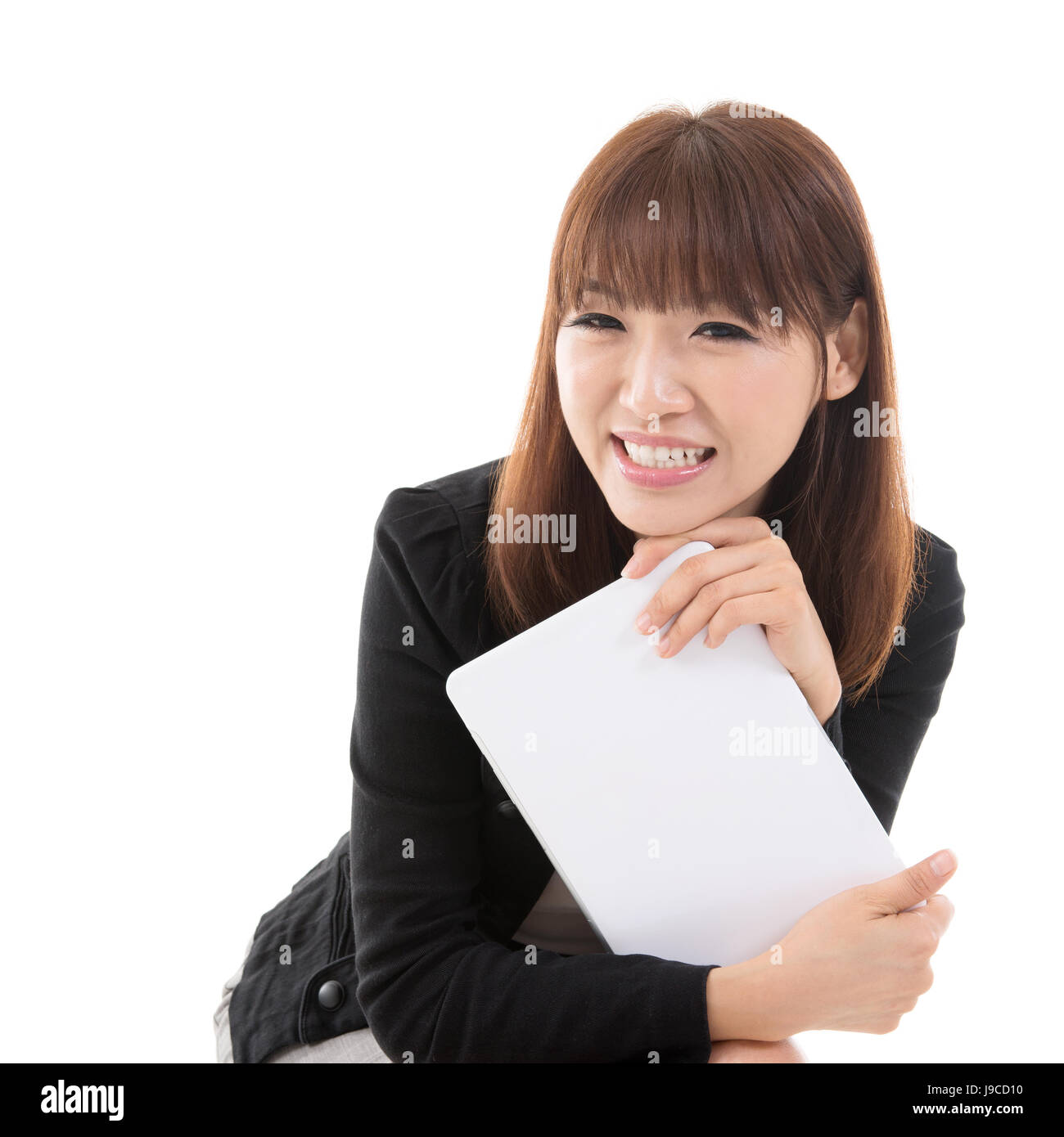 Young Asian girl holding digital computer tablet and smiling, isolated ...