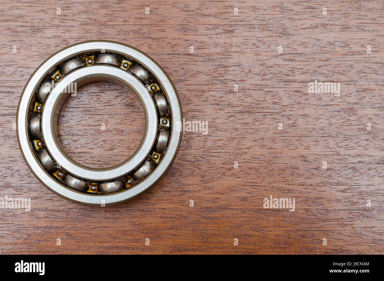 steel ball bearings on wooden table Stock Photo