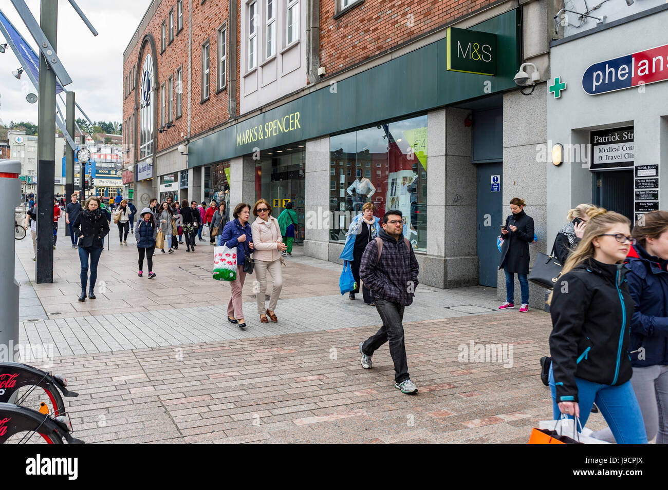 Marks and Spencer M&S with shoppers pedestrians on Patrick Street, Cork, Ireland Stock Photo