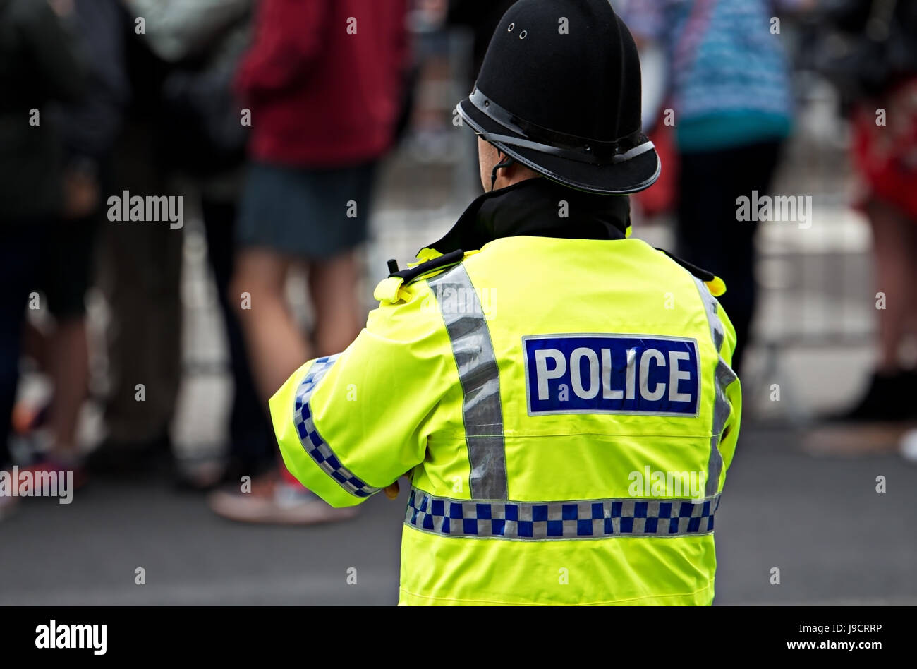 British Police Officer in high visibility uniform on crowd control Stock Photo