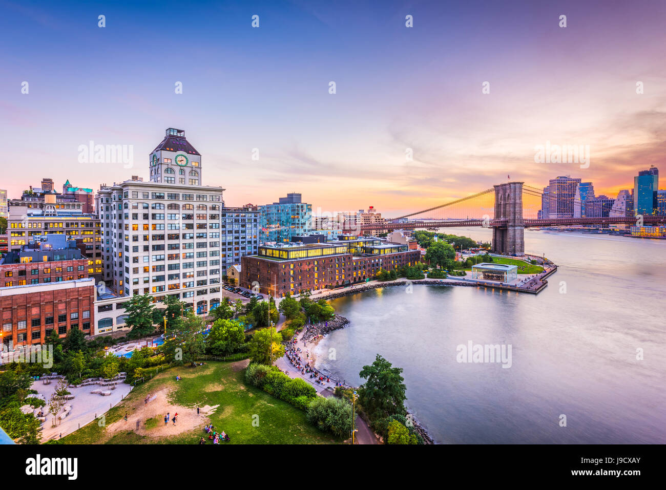 New York City financial district skyline at sunset over the East River. Stock Photo