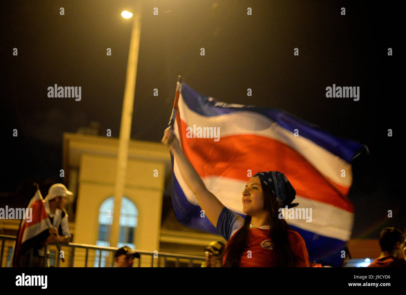 A Costa Rica fan waves a flag in San José after their national team defeated Greece for a spot in the quarterfinals of the World Cup on June 29, 2014. Stock Photo