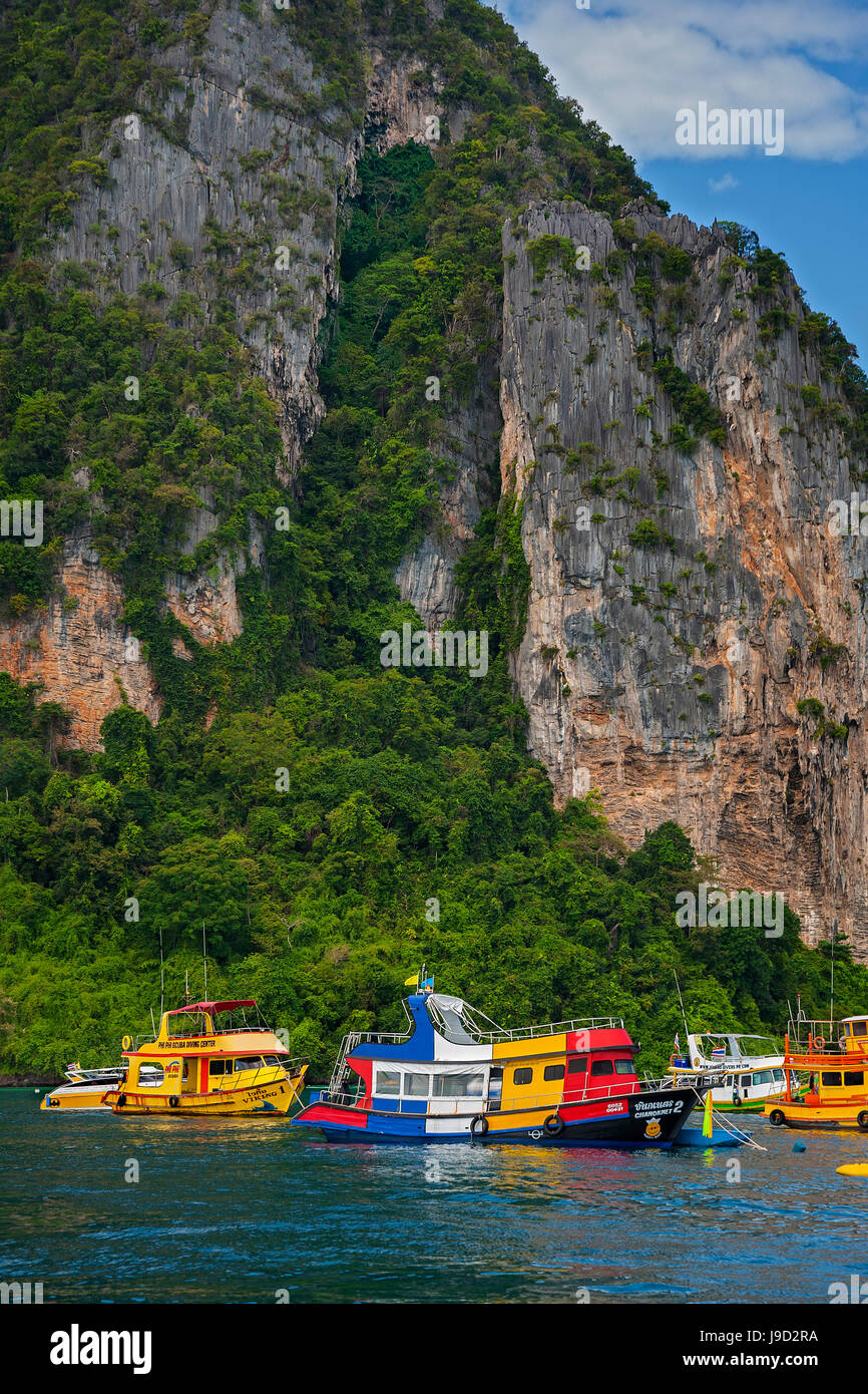 Tourists boats in front of rock face, Ko Phi Phi Island, Phuket, Thailand Stock Photo