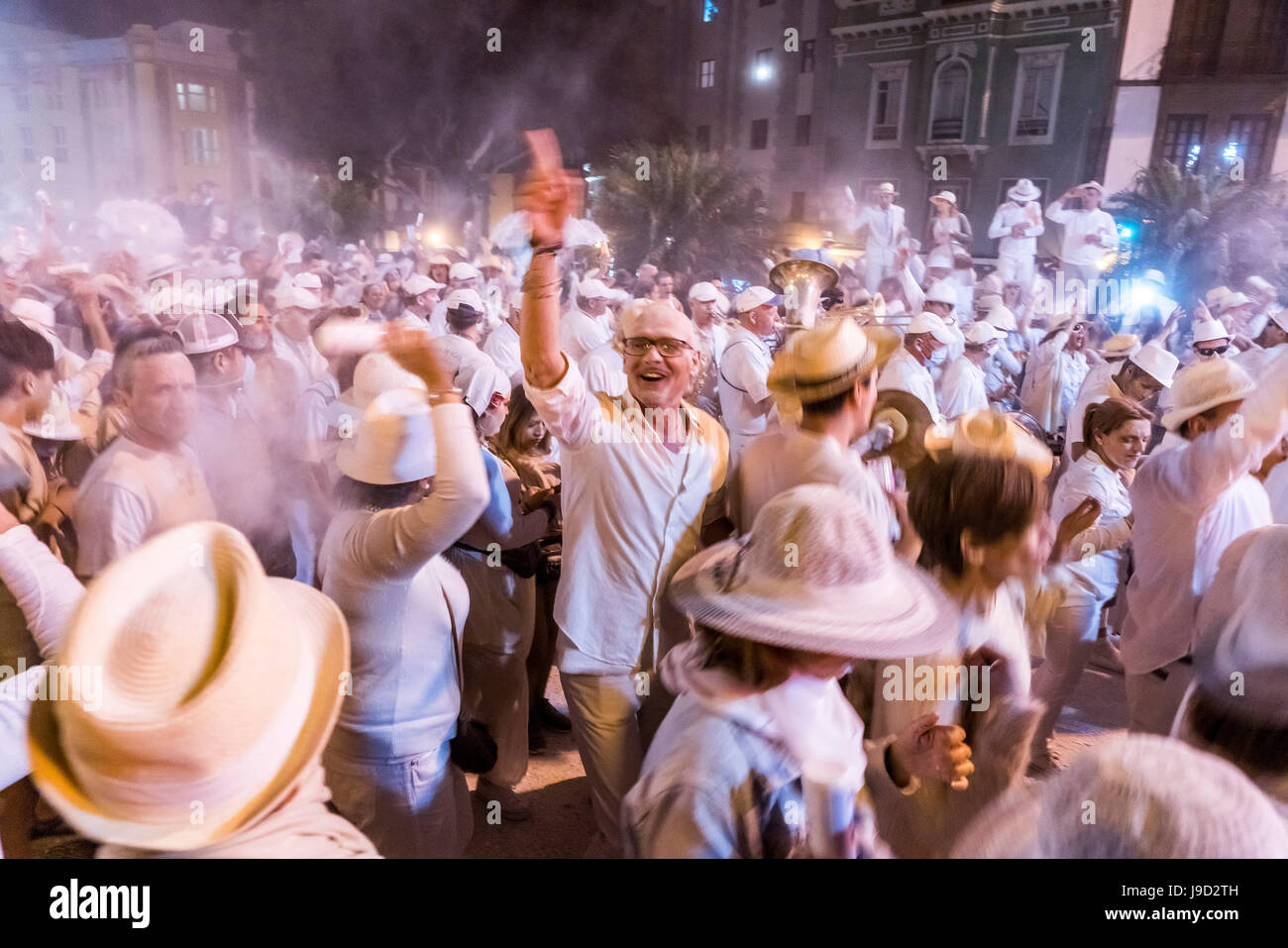 Crowd of people, white powder and white clothes, evening mood, carnival La Fiesta de los Indianos, Las Palmas de Gran Canaria Stock Photo
