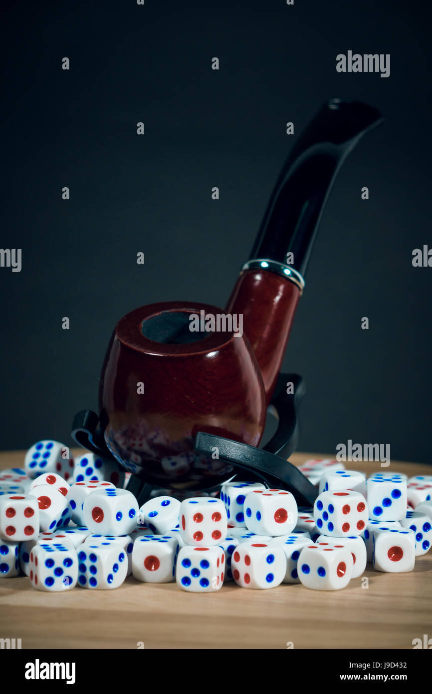 Smoking Tobacco Pipe with many dice Stock Photo Alamy