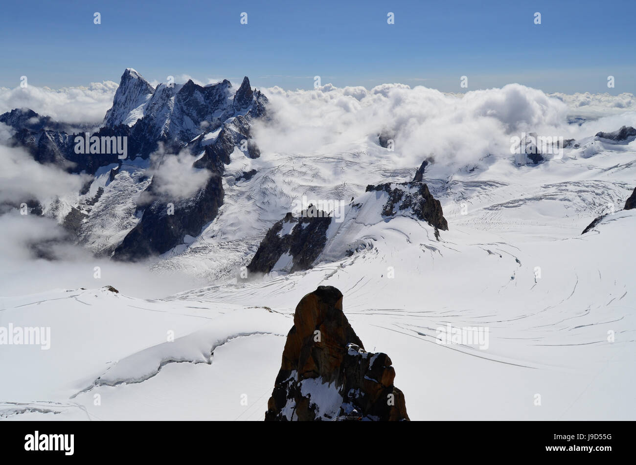 Snowy mountains above the clouds. View from the Aiguille du Midi ...