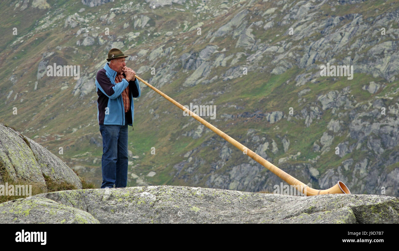 Alpenhorn player at Gotthard Pass, Canton of Uri, Switzerland, Europe Stock Photo