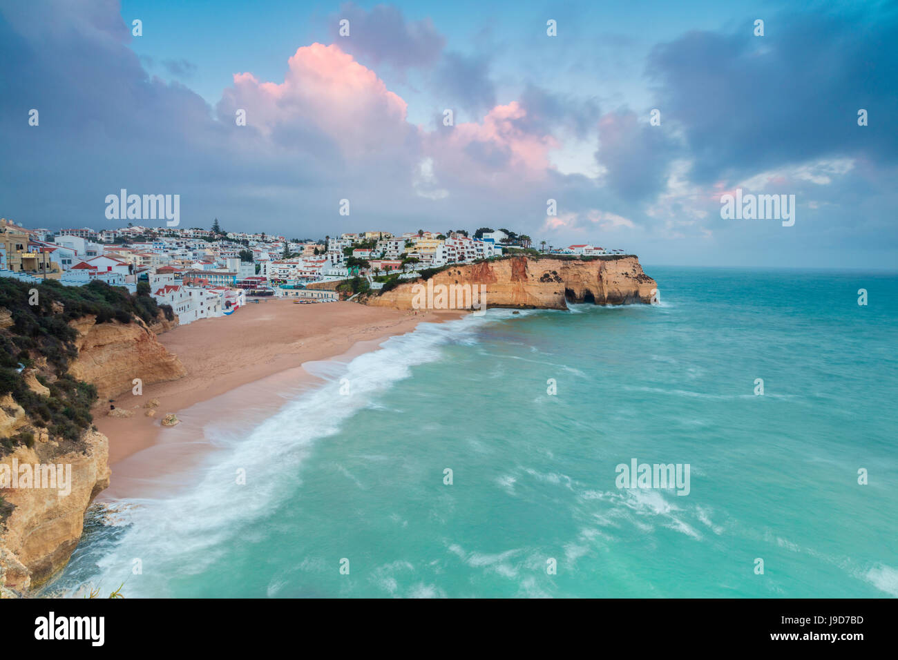 View of Carvoeiro village surrounded by sandy beach and turquoise sea at sunset, Lagoa Municipality, Algarve, Portugal, Europe Stock Photo