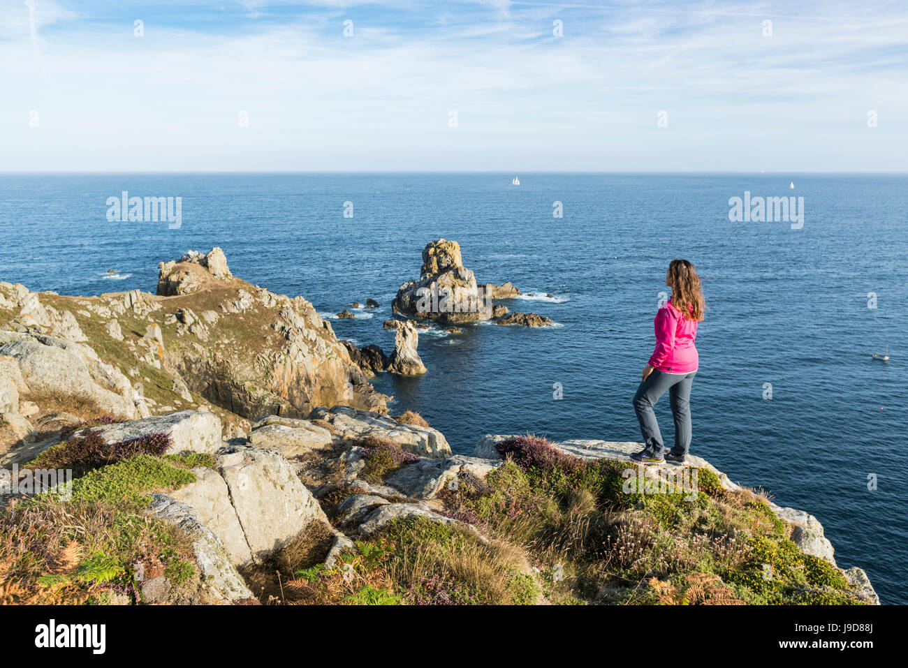 Woman on the cliffs of Van Point, Cleden-Cap-Sizun, Finistere, Brittany, France, Europe Stock Photo