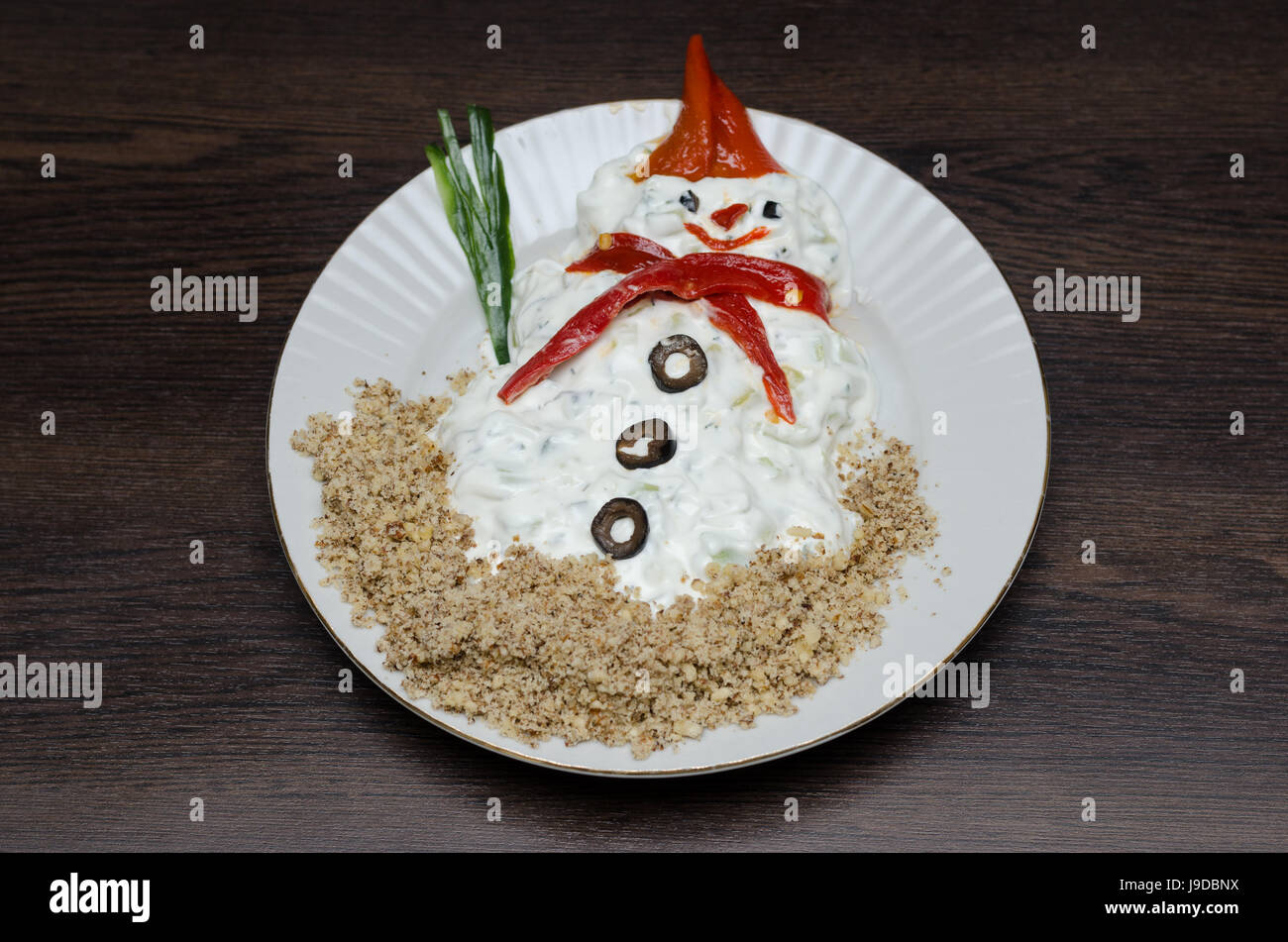 Funny snowman made of white souce in plate Stock Photo