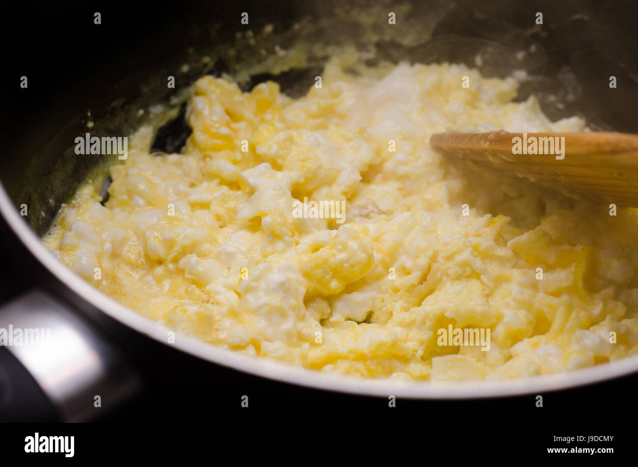 Freshly prepared scrambled eggs in pan Stock Photo