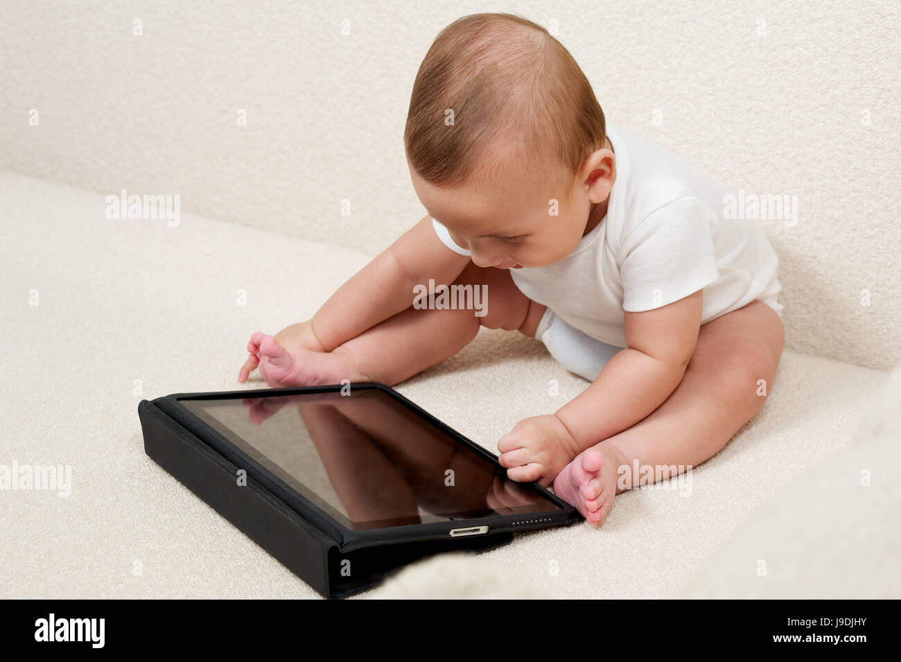 baby playing with computer Stock Photo