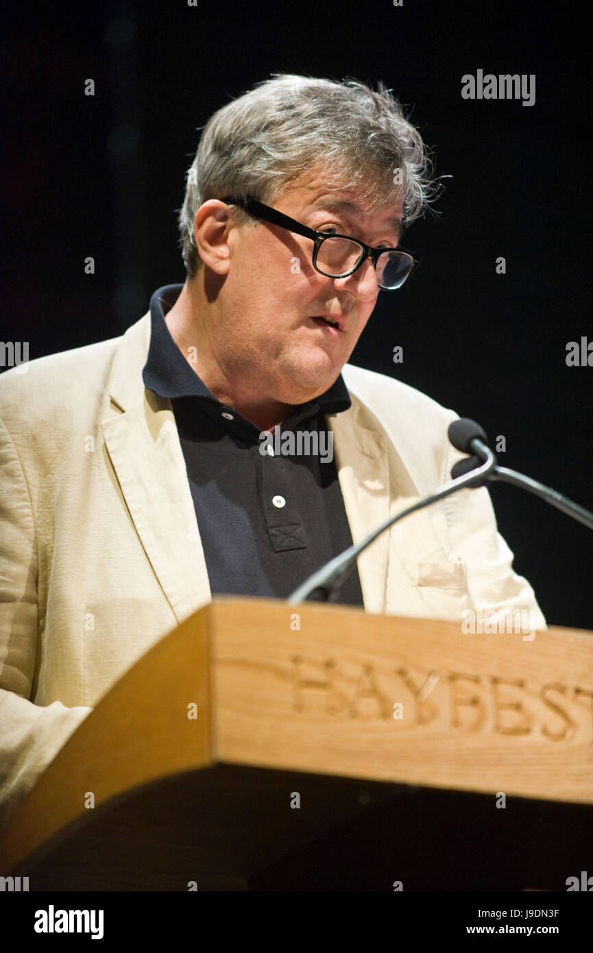 Stephen Fry reading from lectern at Letters Live event at Hay Festival 2017 Hay-on-Wye Powys Wales UK Stock Photo