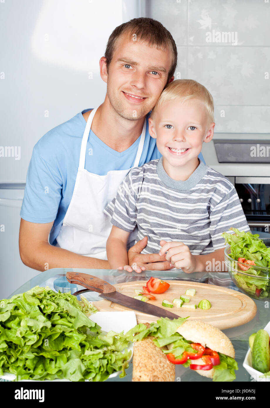 happy young father cooking with his son at home Stock Photo - Alamy