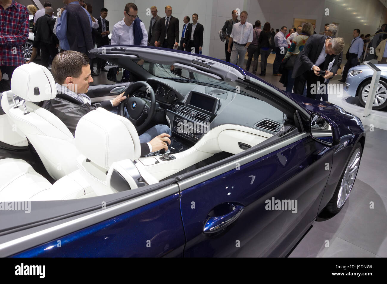 FRANKFURT, GERMANY - SEP 13: Visitor inside a BMW 640i Cabrio at the IAA motor show on Sep 13, 2013 in Frankfurt. More than 1.000 exhibitors from 35 c Stock Photo