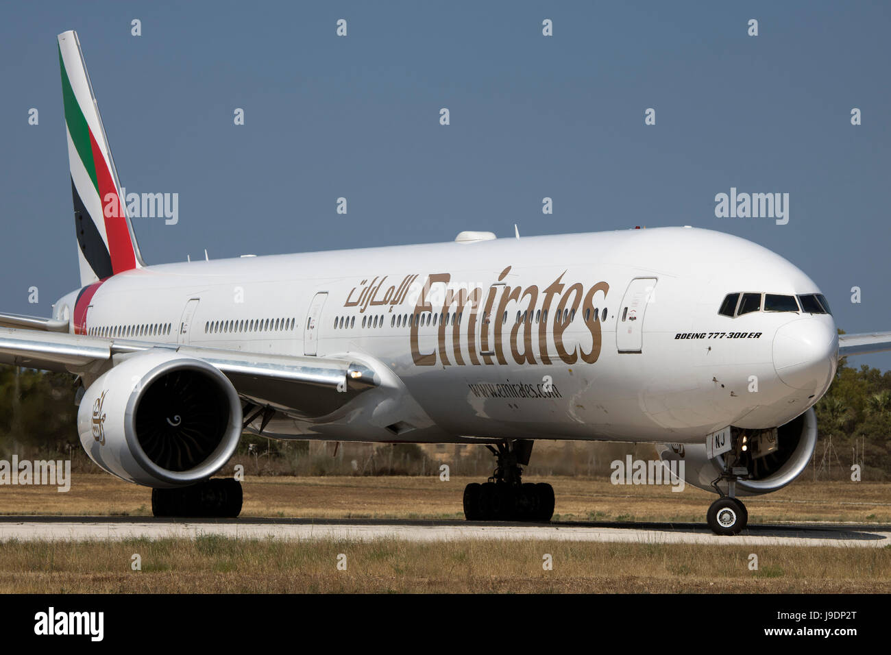 Emirates Boeing 777-31H/ER [A6-ENJ] exiting taxiway 'Foxtrot' for take off from runway 13. Stock Photo