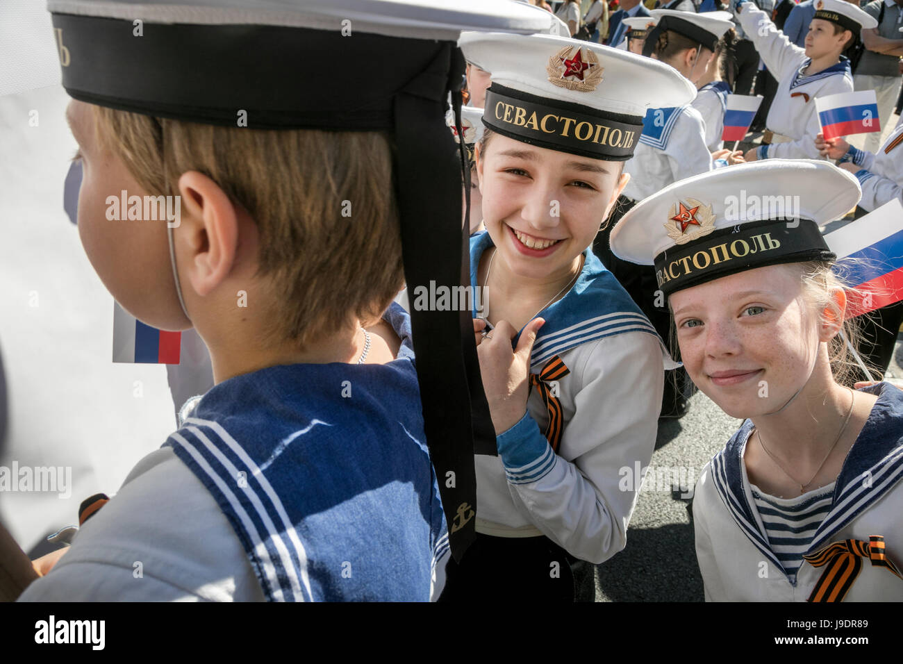 Participants in the May Day march in the form of sailors on the International Workers' Solidarity Day on the main street of Sevastopol town Stock Photo
