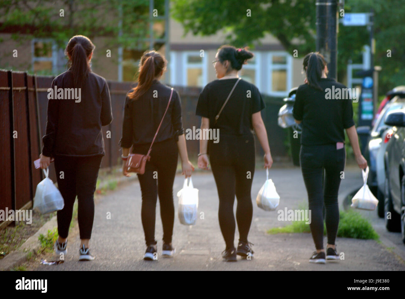 four Chinese take away girls on the streets of Finnieston Glasgow a number 4 Stock Photo