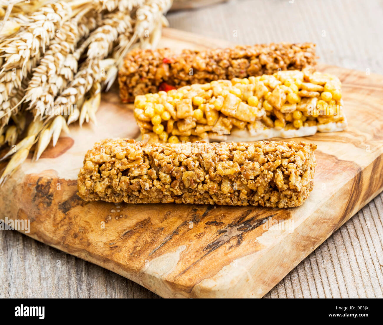 Granola or muesli bars on wooden board , whole wheat protein snacks Stock Photo
