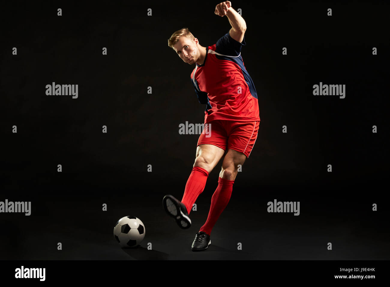 Professional Soccer Player Shooting At Goal In Studio Stock Photo Alamy