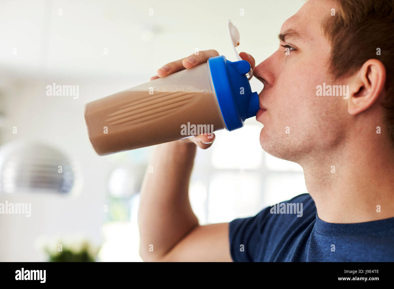 Man Drinking Protein Shake In Kitchen At Home Stock Photo Alamy