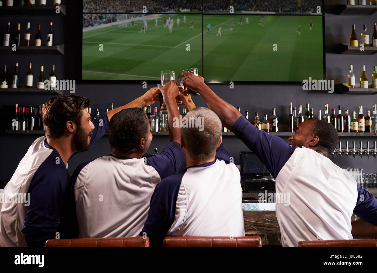 Rear View Of Male Friends Watching Game In Sports Bar Stock Photo Alamy