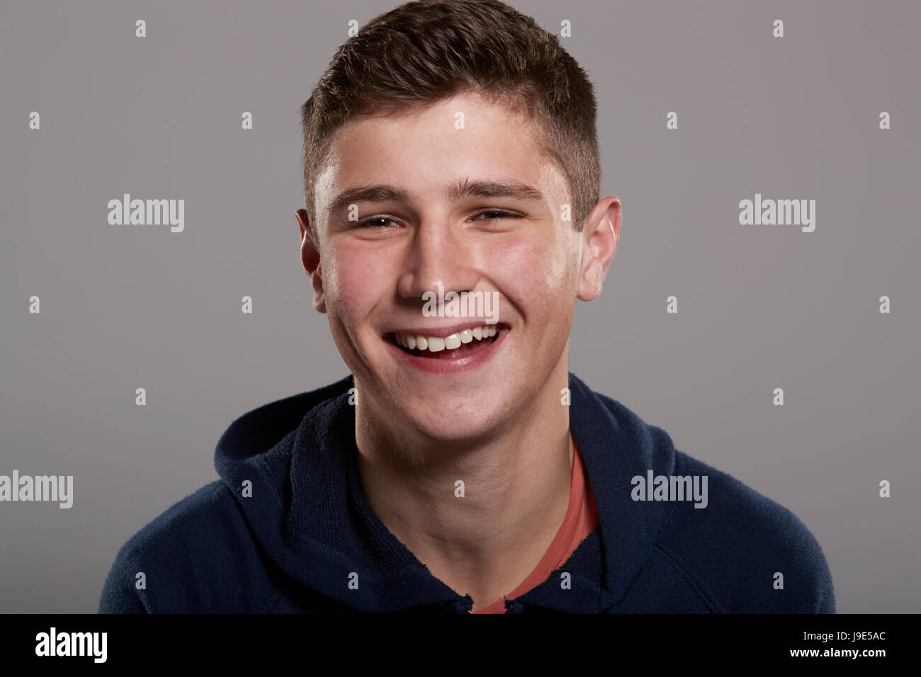 Teenage boy smiling to camera, head and shoulders portrait Stock Photo ...