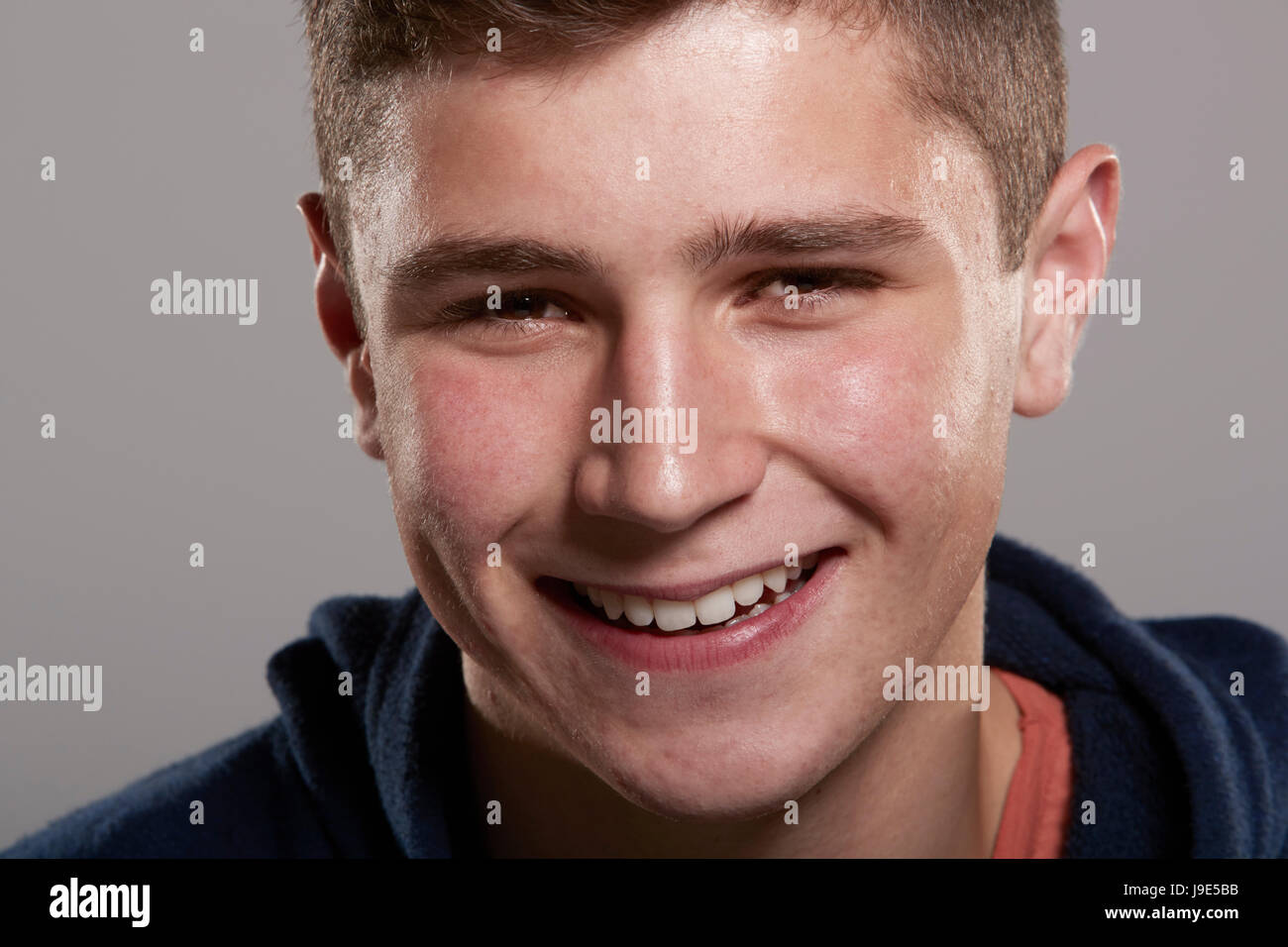 Teenage boy smiling to camera, close up Stock Photo - Alamy