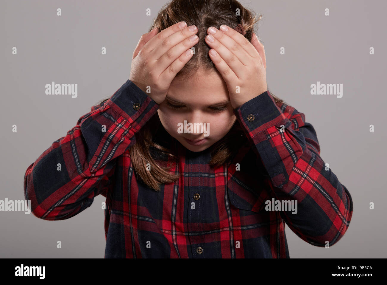 Ten year old girl holding head in frustration, waist up Stock Photo - Alamy