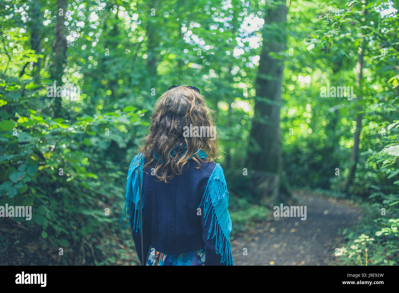 A young woman is walking in the forest Stock Photo - Alamy