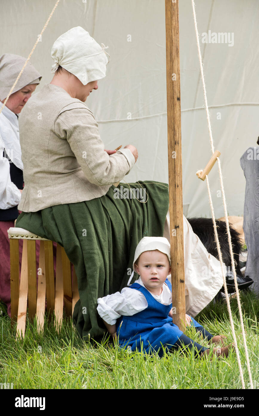 Young girl and mother in an encampment at a Sealed Knot English Civil war reenactment event. Charlton Park, Malmesbury, Wiltshire, UK Stock Photo
