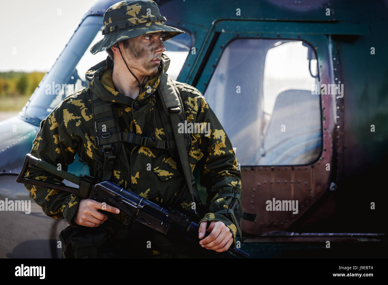 Photo of a soldier with an automatic rifle Stock Photo - Alamy