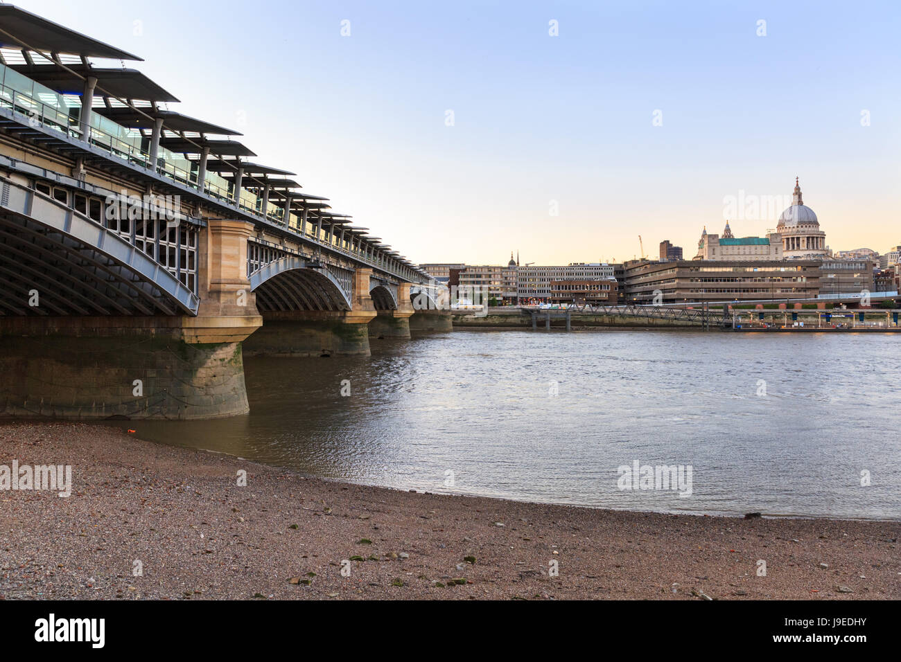 View across the River Thames to Blackfriar's Railway Bridge and St Paul's Cathedral, London, UK Stock Photo