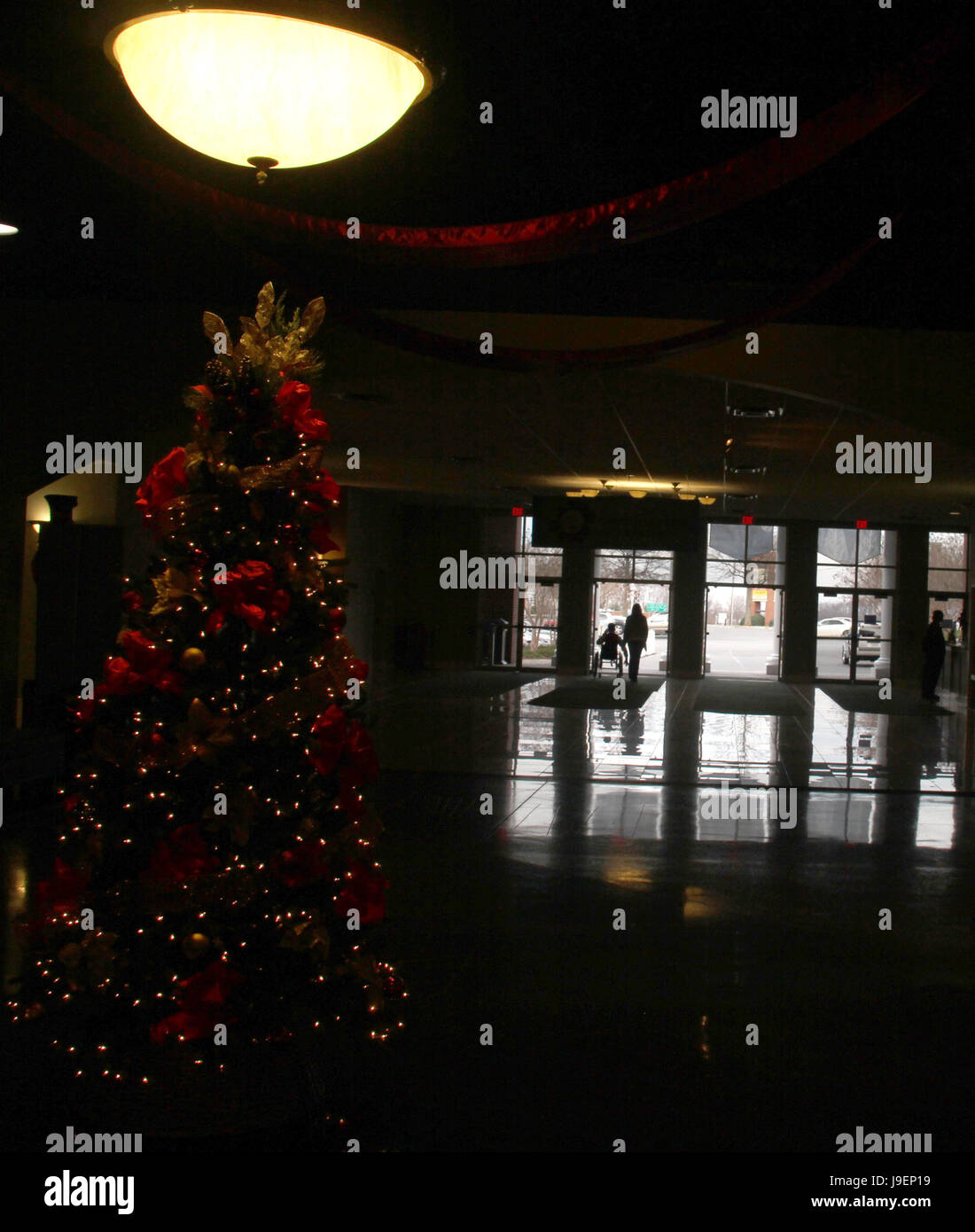 Illuminated Christmas tree on the hallway of large building Stock Photo