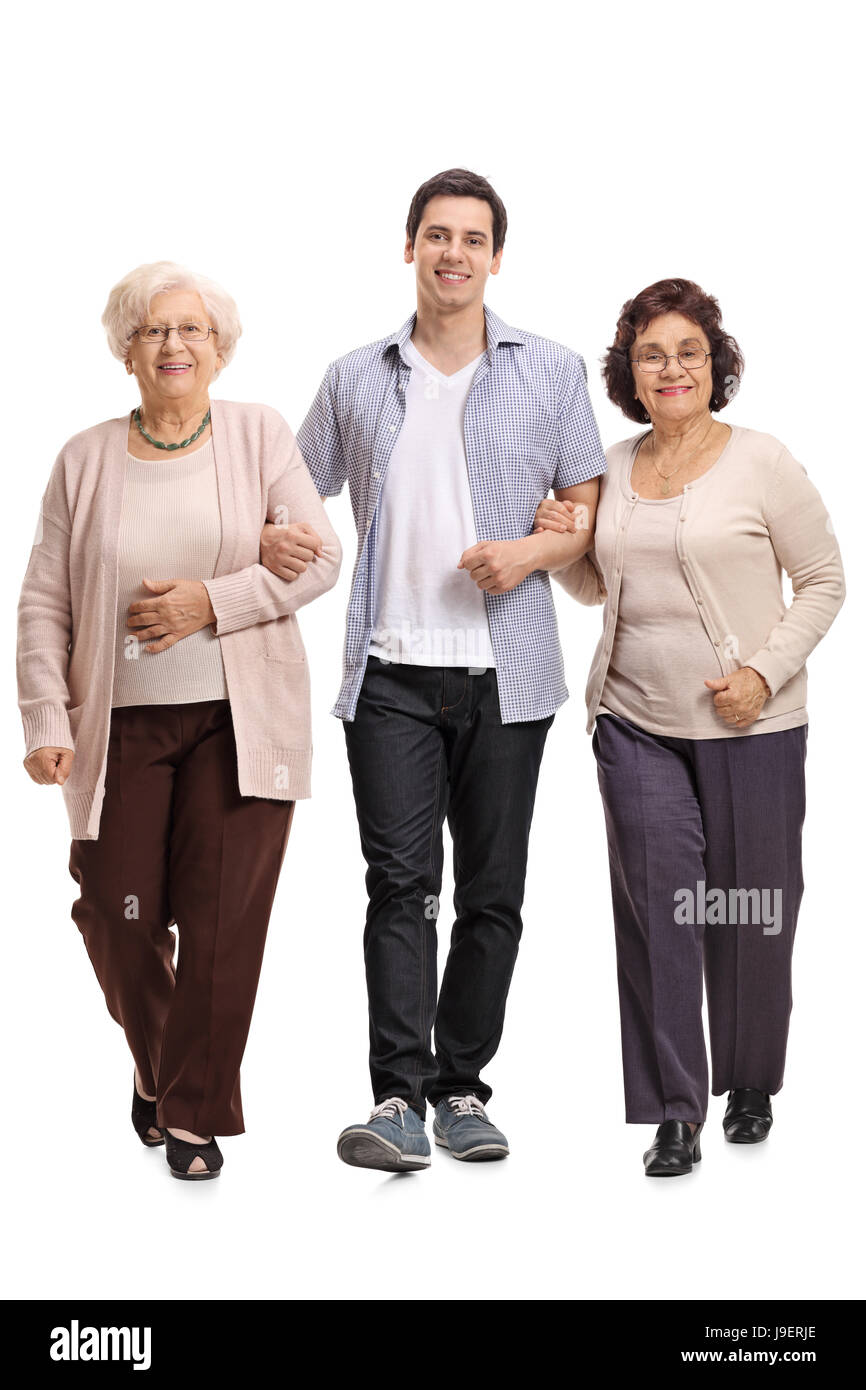 Full length portrait of a young man with two mature women walking towards the camera isolated on white background Stock Photo